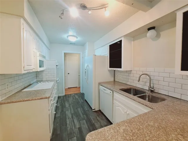 a kitchen with a sink and a refrigerator