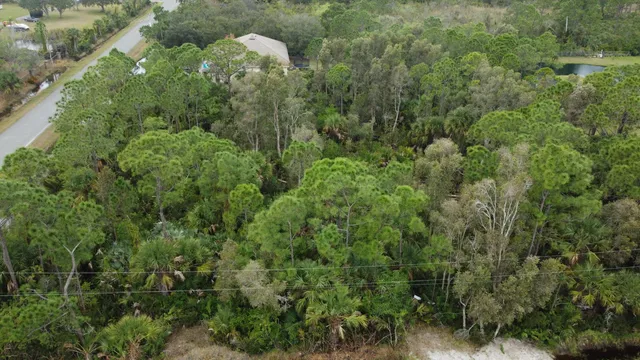an aerial view of a house with yard