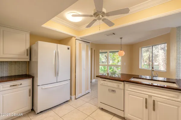 a kitchen with stainless steel appliances granite countertop a sink a stove and a refrigerator