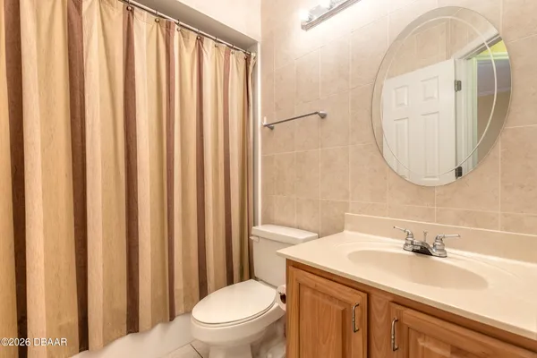 a kitchen with stainless steel appliances granite countertop white cabinets a sink a stove and a window
