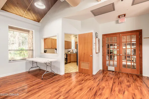 a view of a livingroom with a furniture wooden floor and windows
