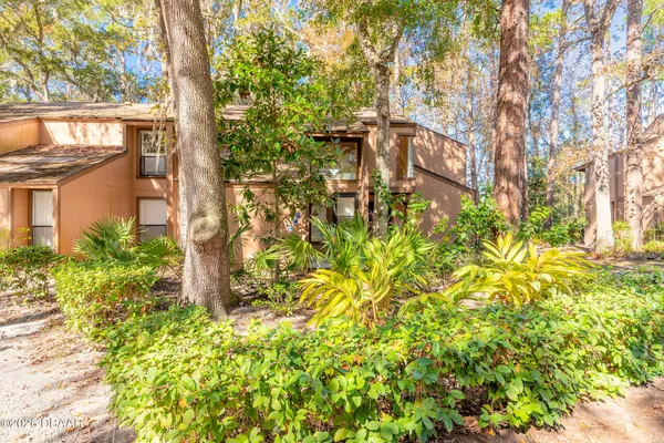 a yellow building with trees in front of it
