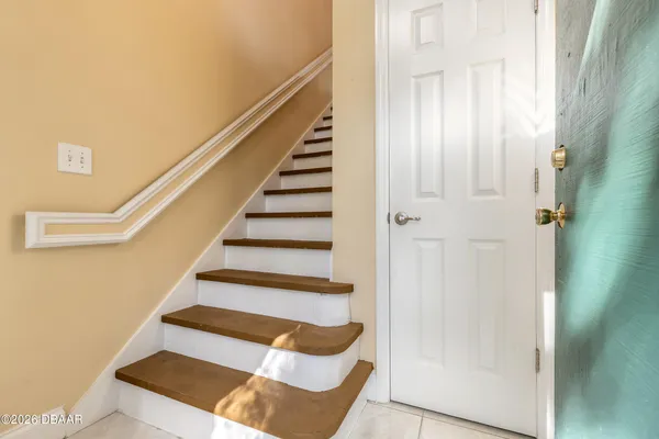 a view of entryway and hall with wooden floor