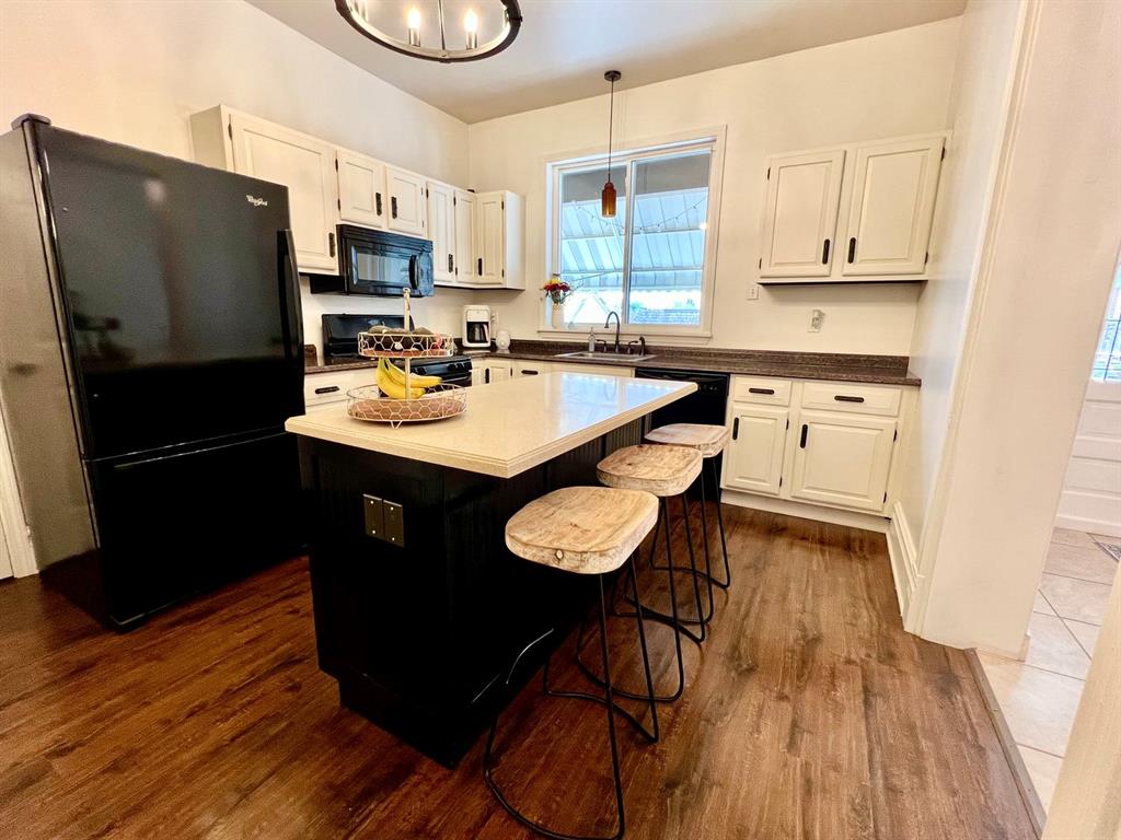 237 Lelia Street Pittsburgh, PA 15211 - Photo 8 of 46 a kitchen with stainless steel appliances granite countertop a sink a stove a refrigerator and cabinets with wooden floor