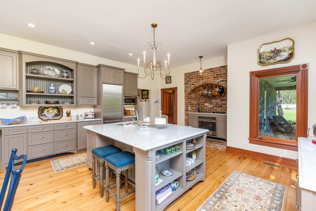 950 Lea Port Road Verona, VA 24482 - Photo 27 of 75 a kitchen that has a lot of cabinets in it and wooden floors