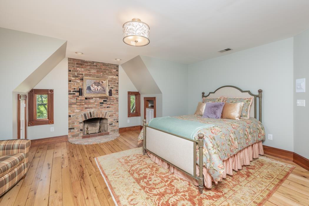 950 Lea Port Road Verona, VA 24482 - Photo 63 of 75 a bedroom with a bed and a fireplace