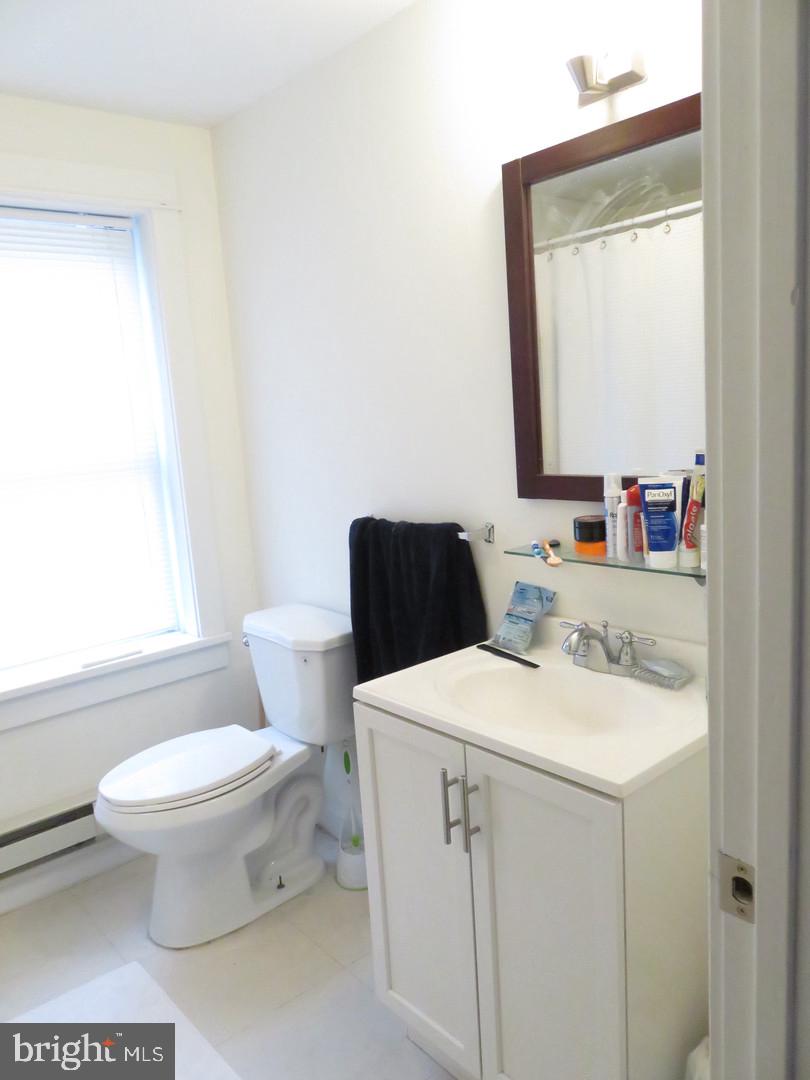 1300 Spruce Street, Unit 3A Philadelphia, PA 19107 - Photo 4 of 9 a bathroom with a sink toilet and mirror