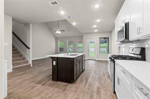 2808 Inn Kitchen Way McKinney, TX 75071 - Photo 6 of 22 White shaker cabinetry, stainless steel range, and built-in microwave