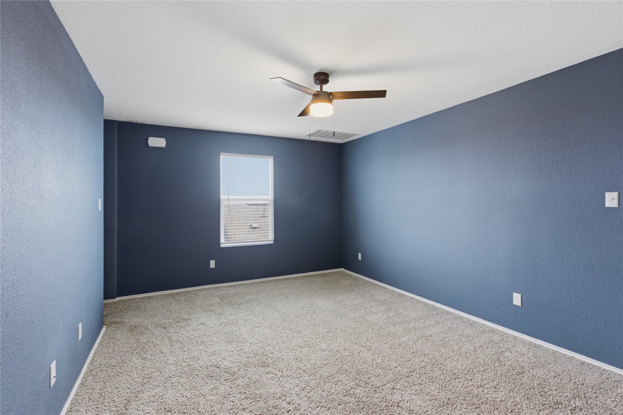 116 Night Riders Way Jarrell, TX 76537 - Photo 21 of 40 Upstairs carpeted room featuring a ceiling fan with integrated lighting, a window with horizontal blinds, and dark gray painted walls