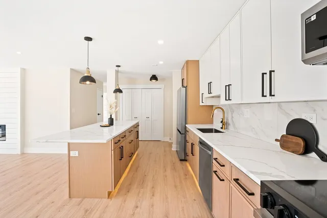 a kitchen with a sink a stove and cabinets