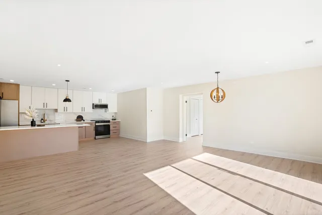 a view of a kitchen with wooden floor