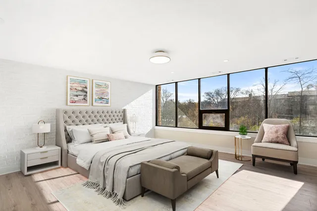 a bedroom with a bed and glass window