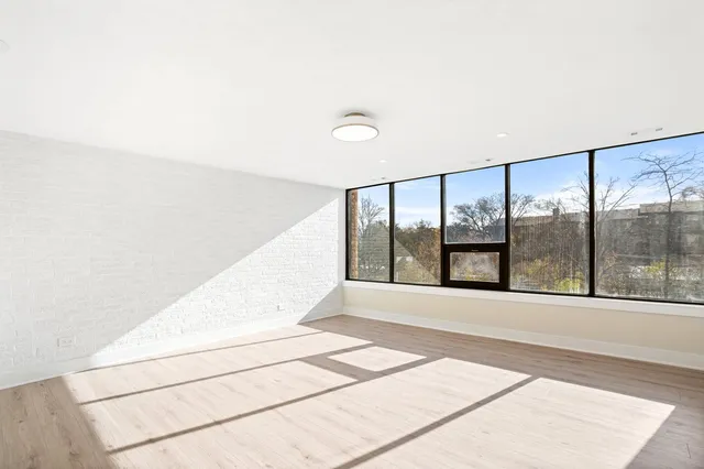 a view of an empty room with a floor to ceiling window