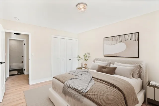 a bedroom with a bed and a painting on the wall