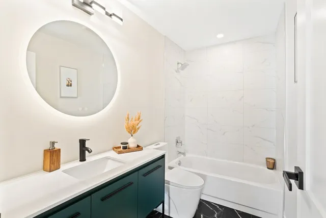 a bathroom with a sink a toilet and a mirror