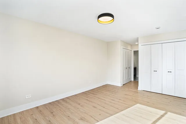 a view of a room with wooden floor and bathroom