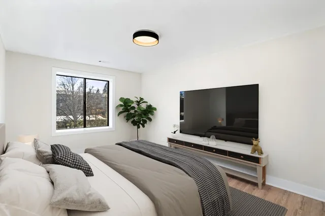 a bedroom with a bed and a flat screen tv