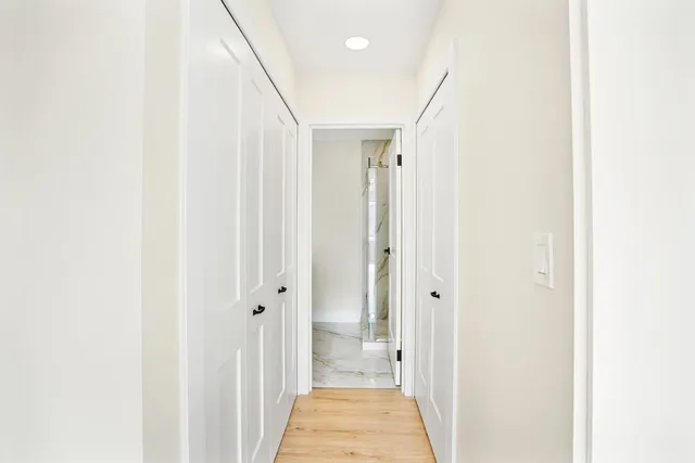 a view of a hallway with a white walls