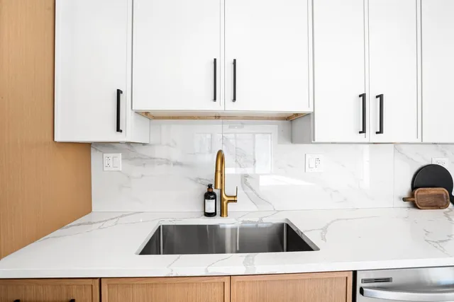 a kitchen with kitchen island a sink a counter and cabinets