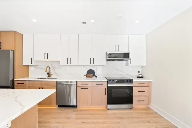 a kitchen with a stove a sink and a refrigerator