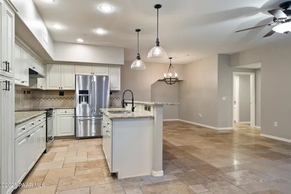 a kitchen with refrigerator and cabinets