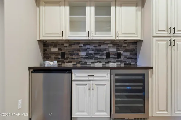 a kitchen with granite countertop white cabinets and sink