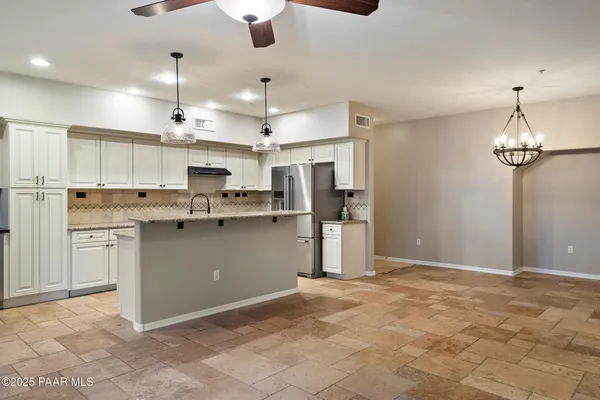 a view of kitchen with stainless steel appliances cabinets a sink and a counter top space
