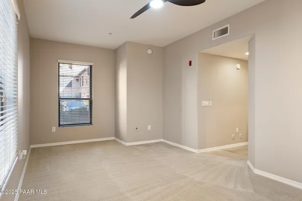 a view of walk in closet with empty racks