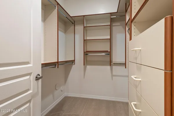 a bathroom with a granite countertop toilet a sink and a mirror