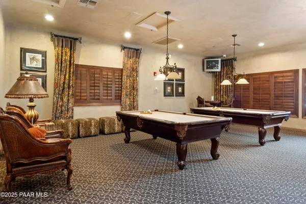 a view of a swimming pool with sitting area