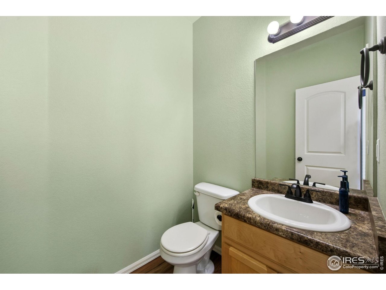 1204 5th Street Pierce, CO 80650 - Photo 16 of 44 a bathroom with a granite countertop sink and a mirror