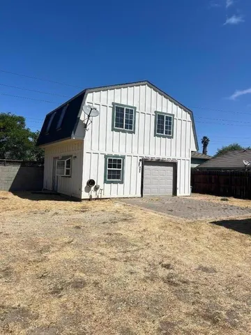 a big house with a big yard and large trees