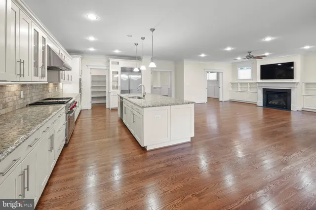 a view of a livingroom with wooden floor and stairs
