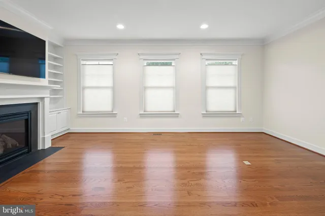 a bedroom with a large bed chandelier and a window
