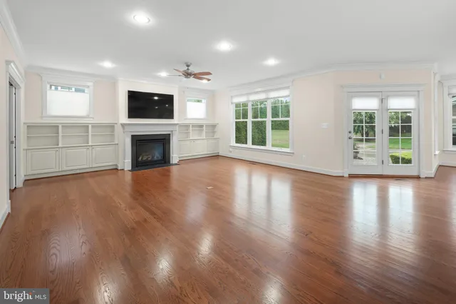 a bedroom with a bed and a potted plant next to a window