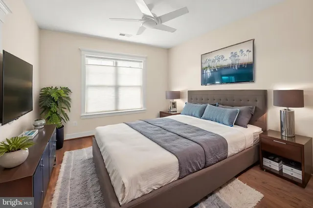 a view of a hallway with wooden floor and entryway