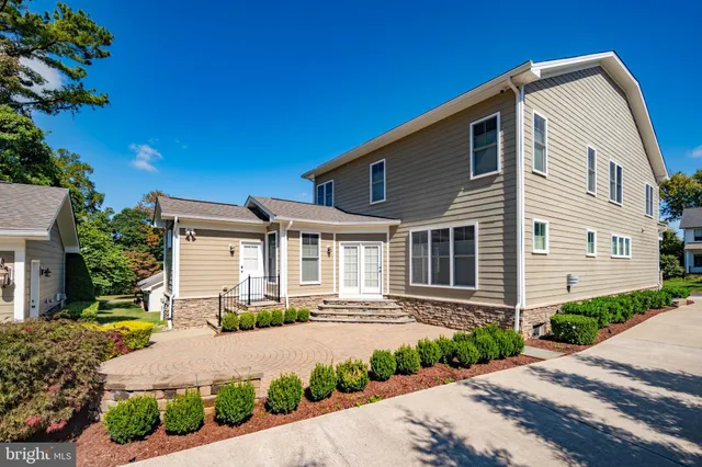 a front view of a house with a yard and outdoor seating