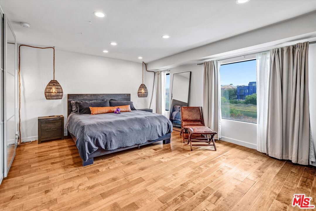 4105 Pacific Avenue, Unit 1 Marina del Rey, CA 90292 - Photo 12 of 29 a bedroom with a bed and wooden floor