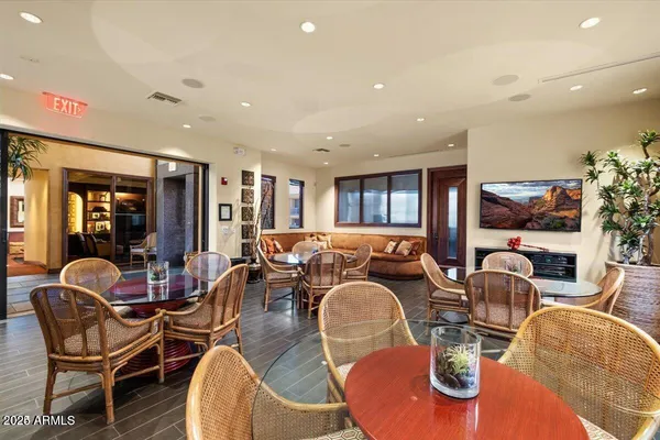 a dining room with furniture a kitchen view and chandelier
