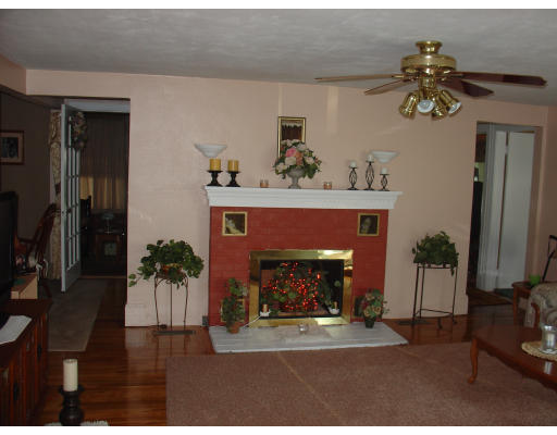 270 Oak Street Springfield, MA 01151 - Photo 3 of 11 a living room with furniture a chandelier and a fireplace