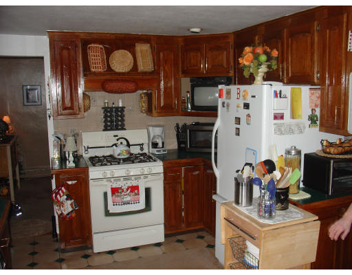 270 Oak Street Springfield, MA 01151 - Photo 5 of 11 a kitchen with stainless steel appliances granite countertop a stove refrigerator sink and cabinets