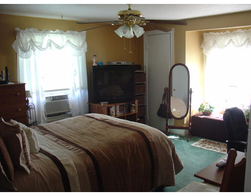 270 Oak Street Springfield, MA 01151 - Photo 7 of 11 a bedroom with a bed and a fireplace