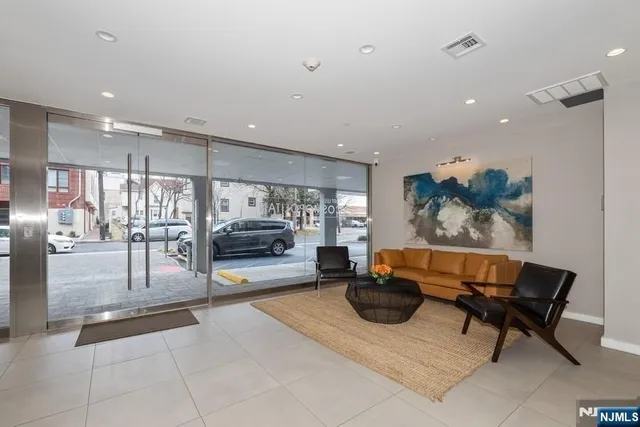 a lobby with furniture and a potted plant