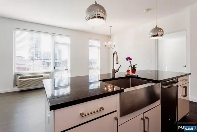 a kitchen with a stove a faucet a sink and cabinets