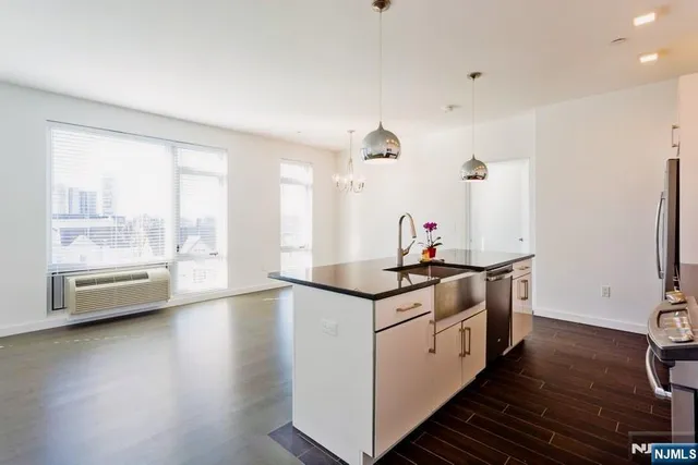 a kitchen with stainless steel appliances a stove and a large window