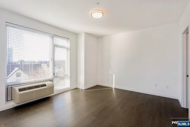 a view of wooden floor and windows in a room