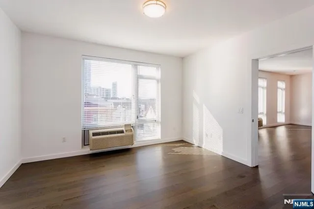 a view of a room with wooden floor and window
