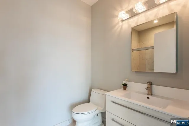 a white toilet sitting next to a bathroom sink