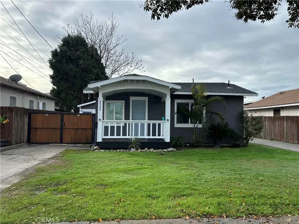 a view of a house with a yard and sitting area