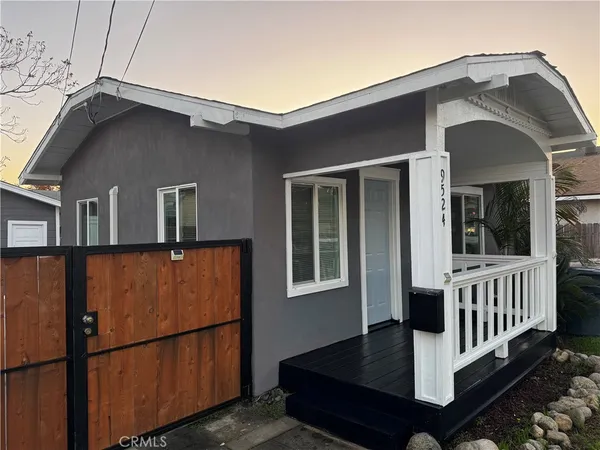 a front view of a house with wooden fence